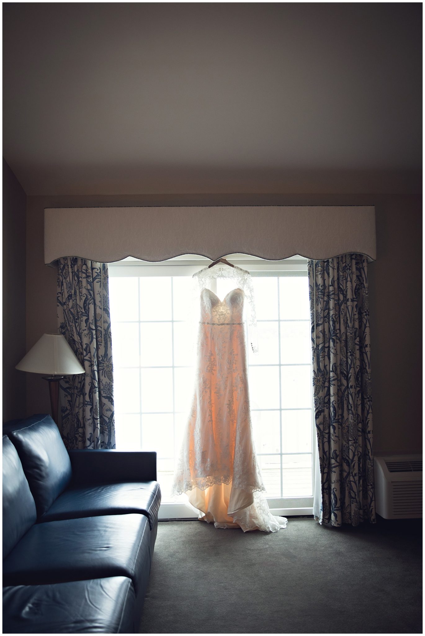 Vintage style dress hanging in bridal suite at Bay Pointe Inn on Gun Lake photographed by Gregersen Photography 