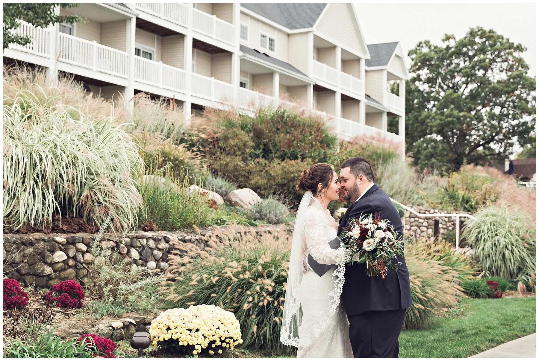 Couple snuggling together for pictures at Bay Pointe Inn on Gun Lake photographed by Melissa Gregersen Photography