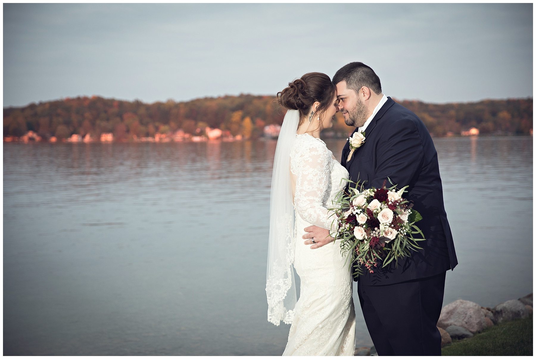 Bride and groom at sunset at Bay Pointe Inn on Gun Lake photographed by Melissa Gregersen Photography