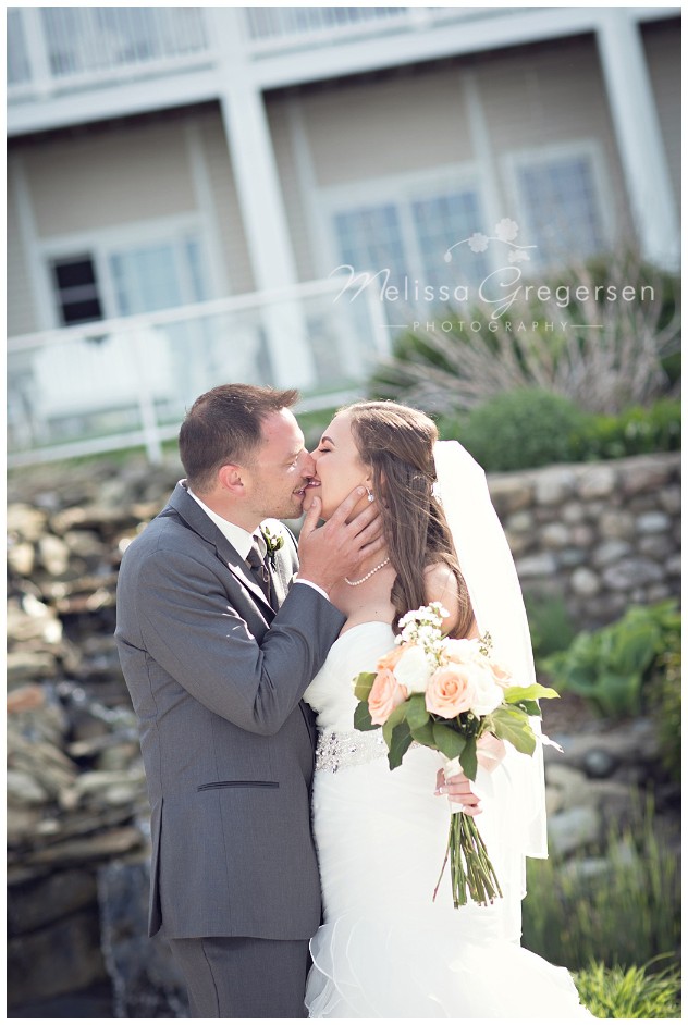kisses and all smiles on their wedding day at Bay Pointe Inn on Gun Lake photographed by Melissa Gregersen Photography