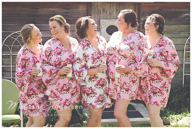 Bridesmaids have all the fun in their cute floral robes at the vintage rose barn