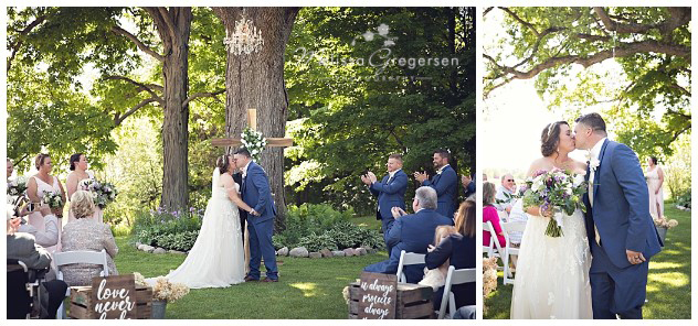 First kiss as husband and wife under the chandelier in the trees at the vintage rose barn