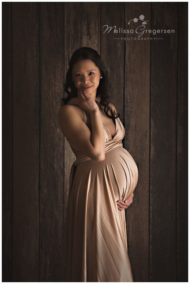 Mother wearing a gorgeous gold maternity dress