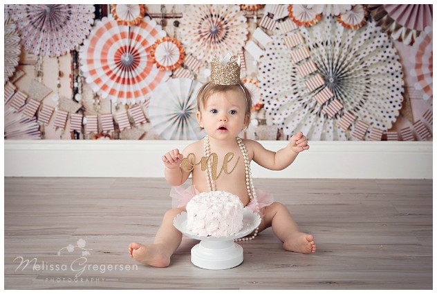 Cake smash photography session with gold and pink colors