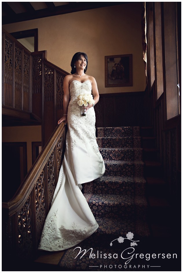 The dark wood staircase shows off the brides brilliant white dress perfectly!