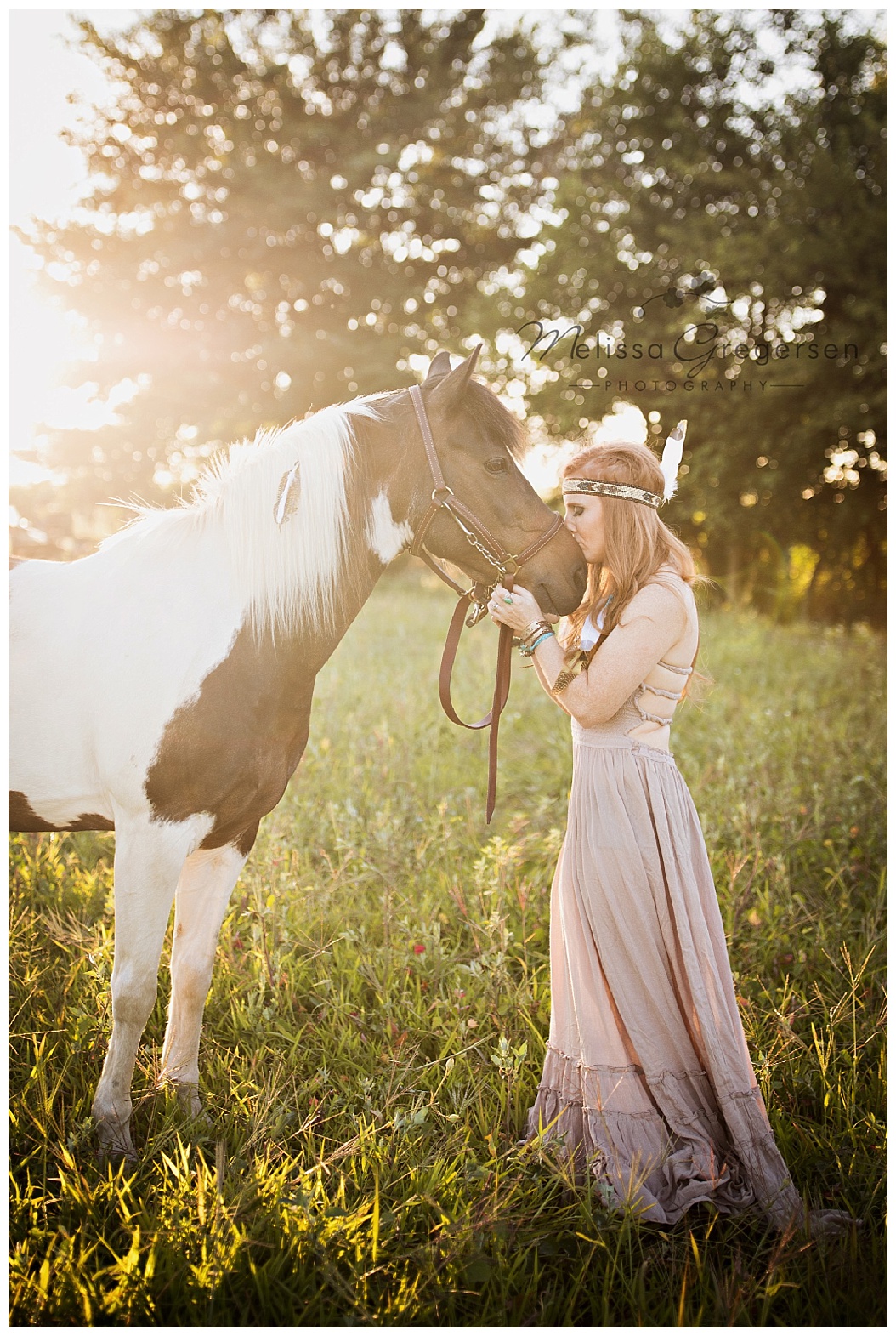 The sun glare really sets off this image of a horse and it's faithful human companion.
