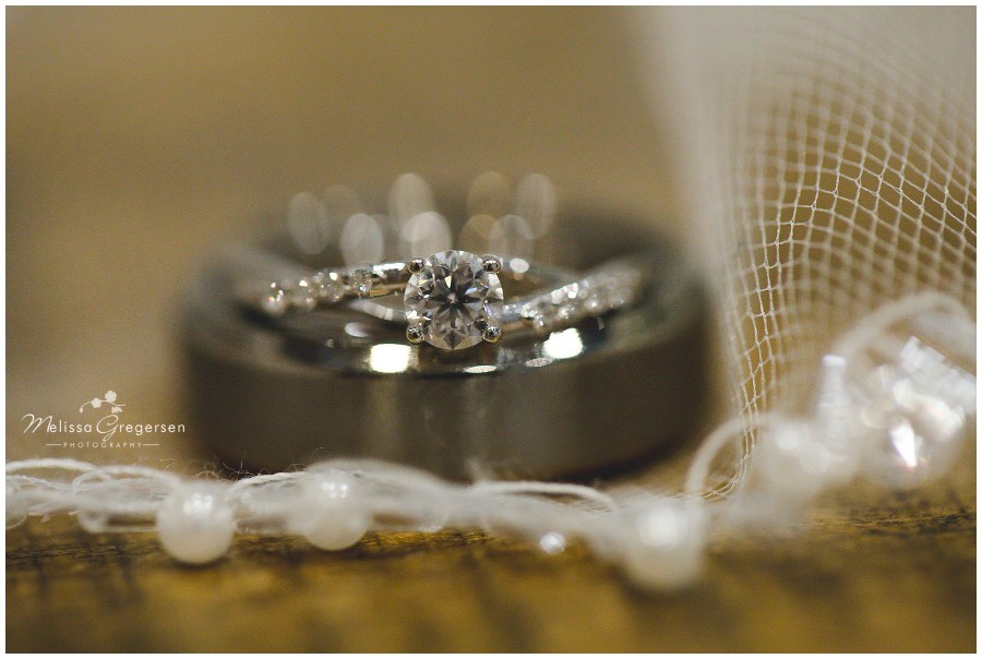 Wedding rings laying on bridal veil