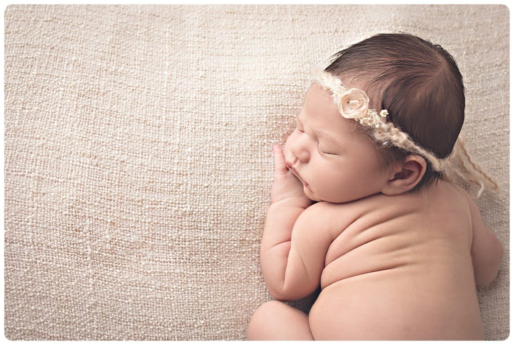 Newborn baby girl photograph with cream neutral colors