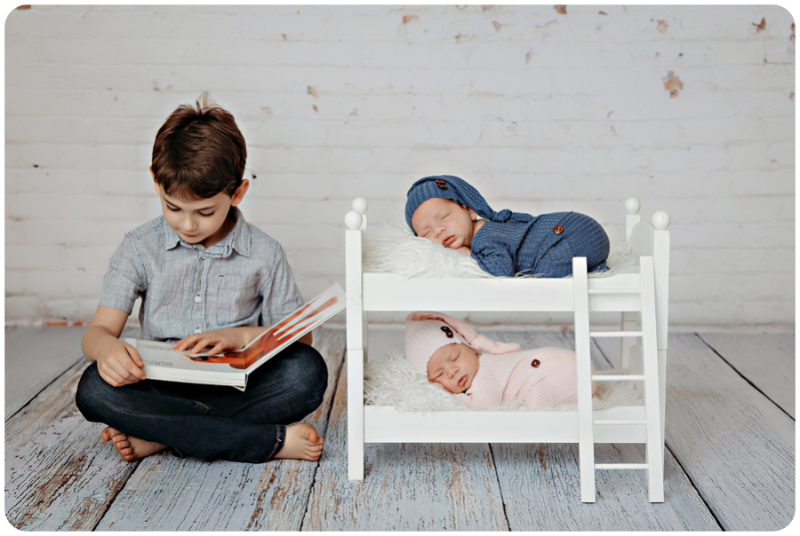 big brother reads to newborn twins