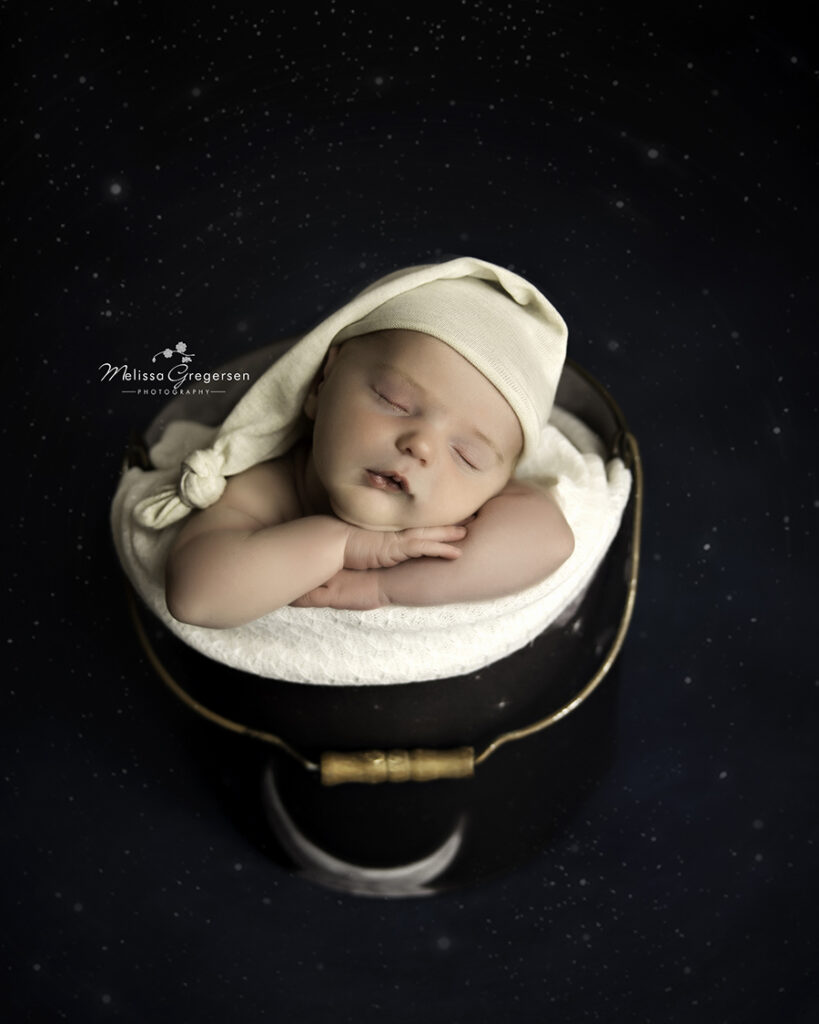 newborn baby in a bucket surrounded by stars kalamazoo newborn photographer