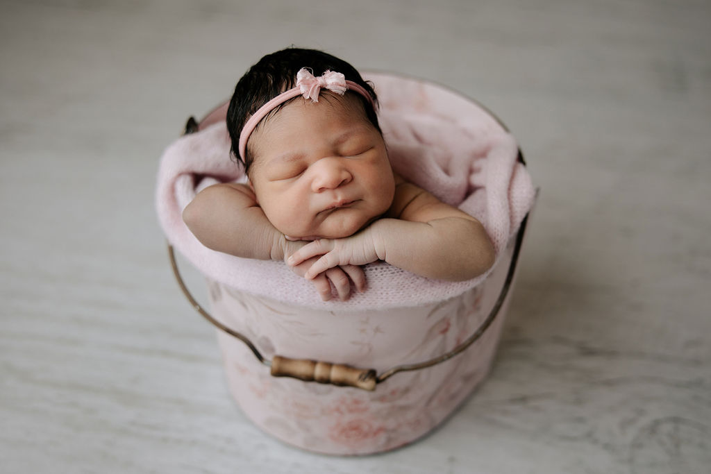 newborn baby photographed in a pink floral bucket Gregersen Photography